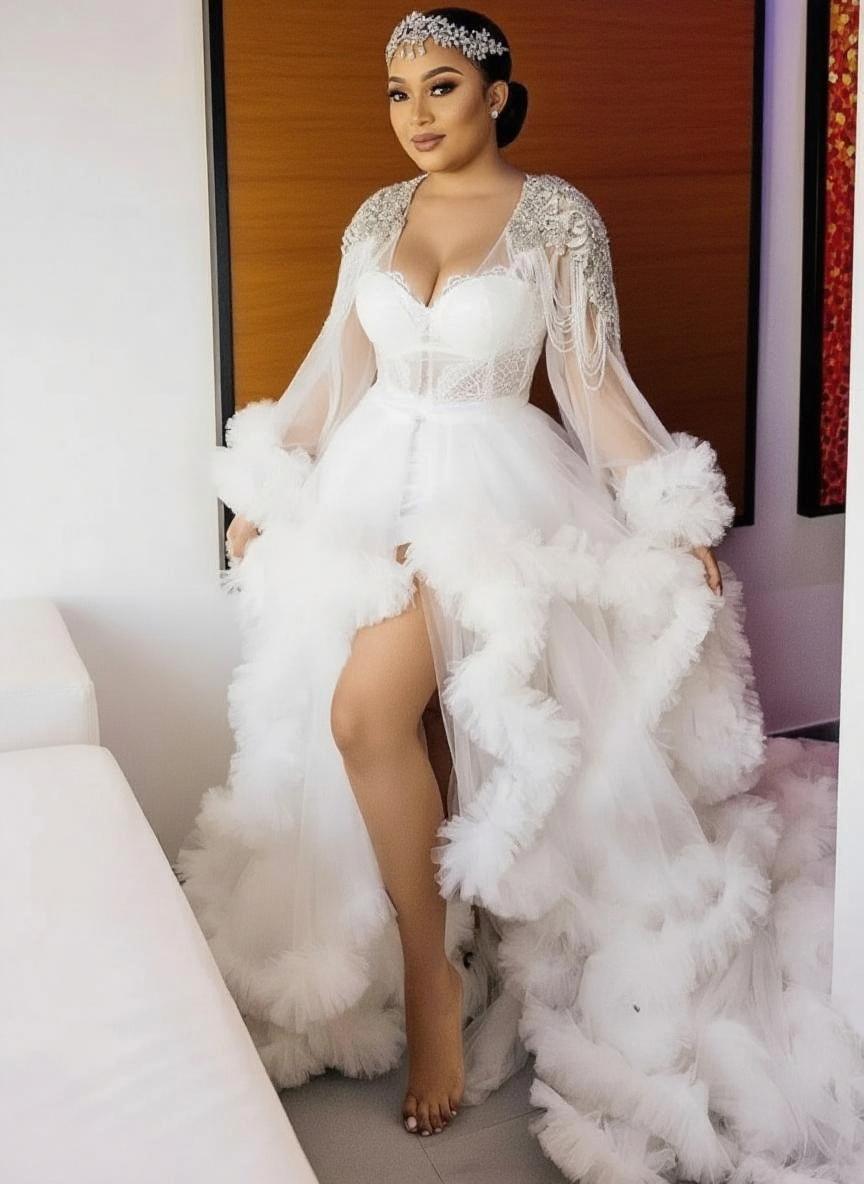 Uniquely designed Monarch length lace and yarn puffed floral full sleeve bridal dress