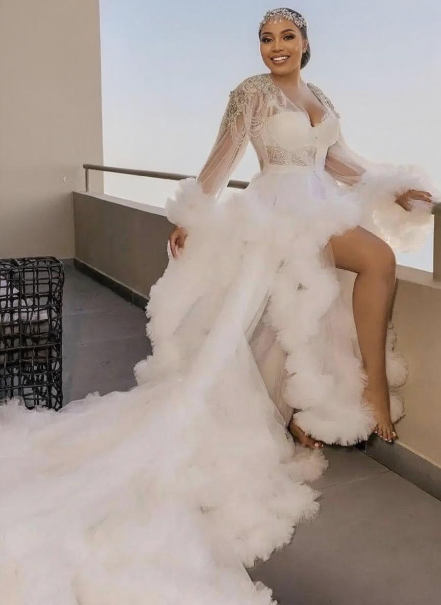 Uniquely designed Monarch length lace and yarn puffed floral full sleeve bridal dress